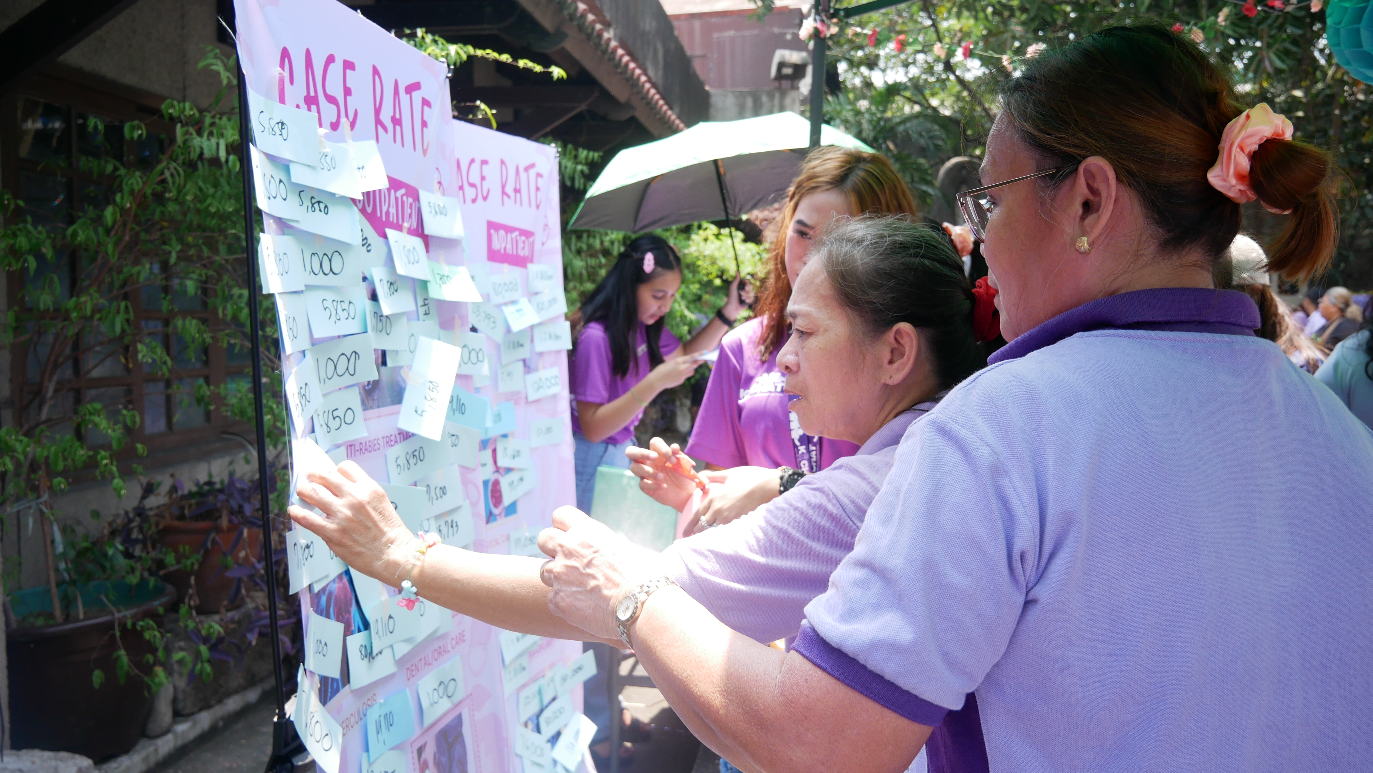 6 EI staff facilitates roulette where participants guess the case rates of common health conditions that they hit.JPG